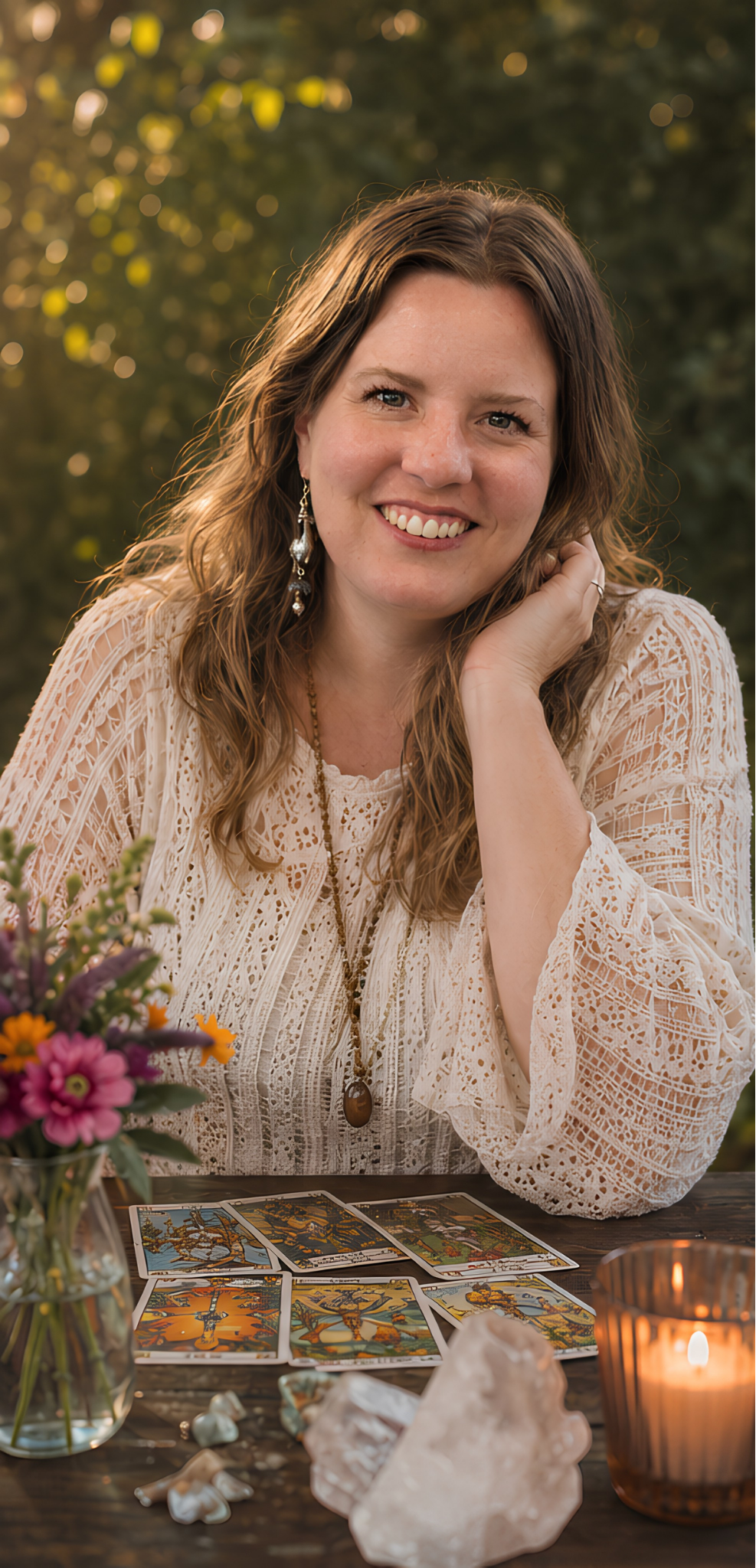 Katie, a Denver tarot reader, smiling outdoors with wildflowers in the foreground